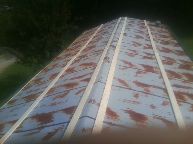 Rusted metal roof panels with new wood purlins before replacement — Storm Damage Roof Repair in Nesmith by Roofing Brothers